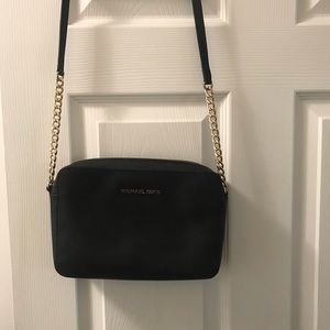 Black Michael Kors cross body purse.